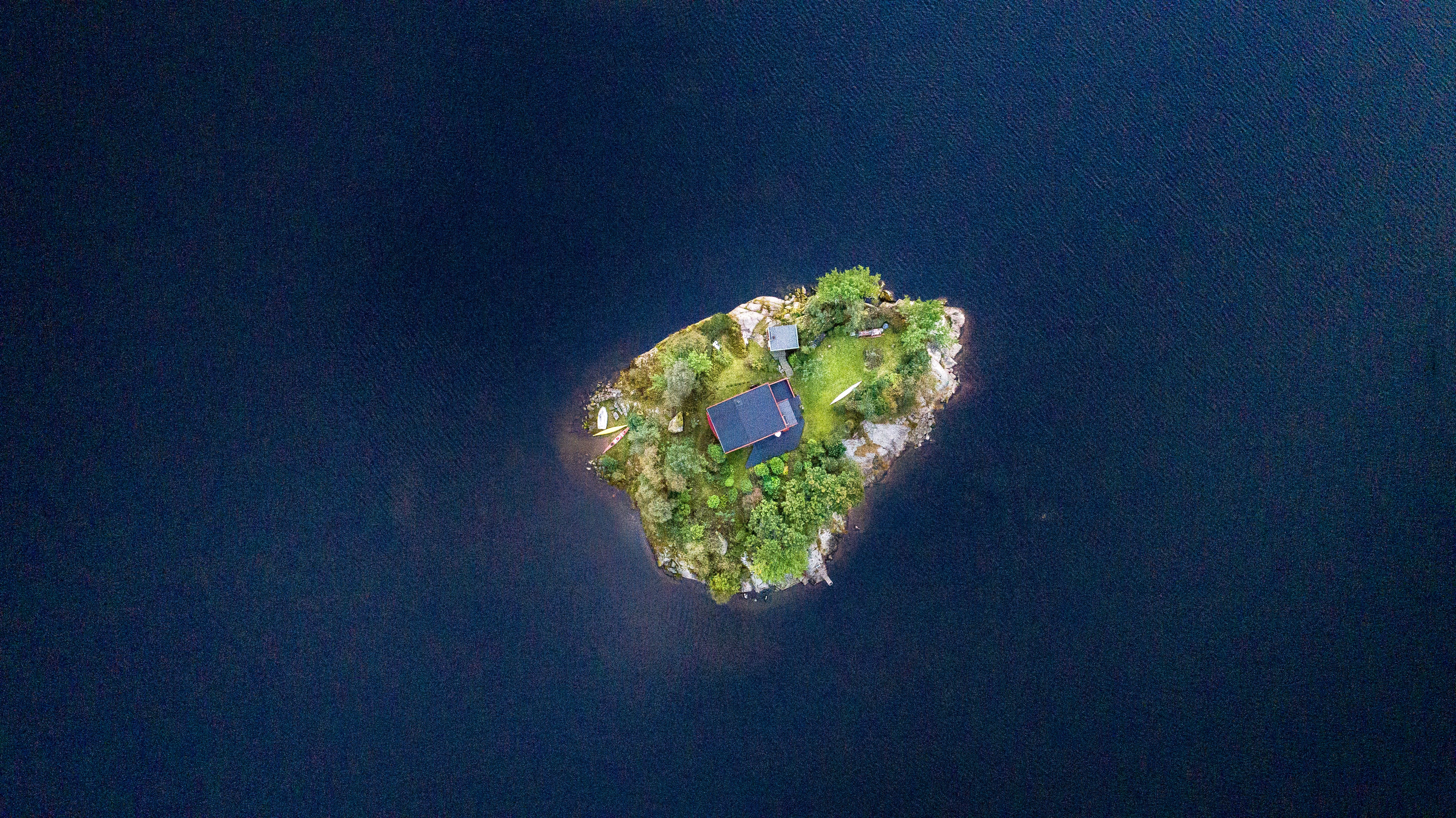aerial photography of blue building in middle of island